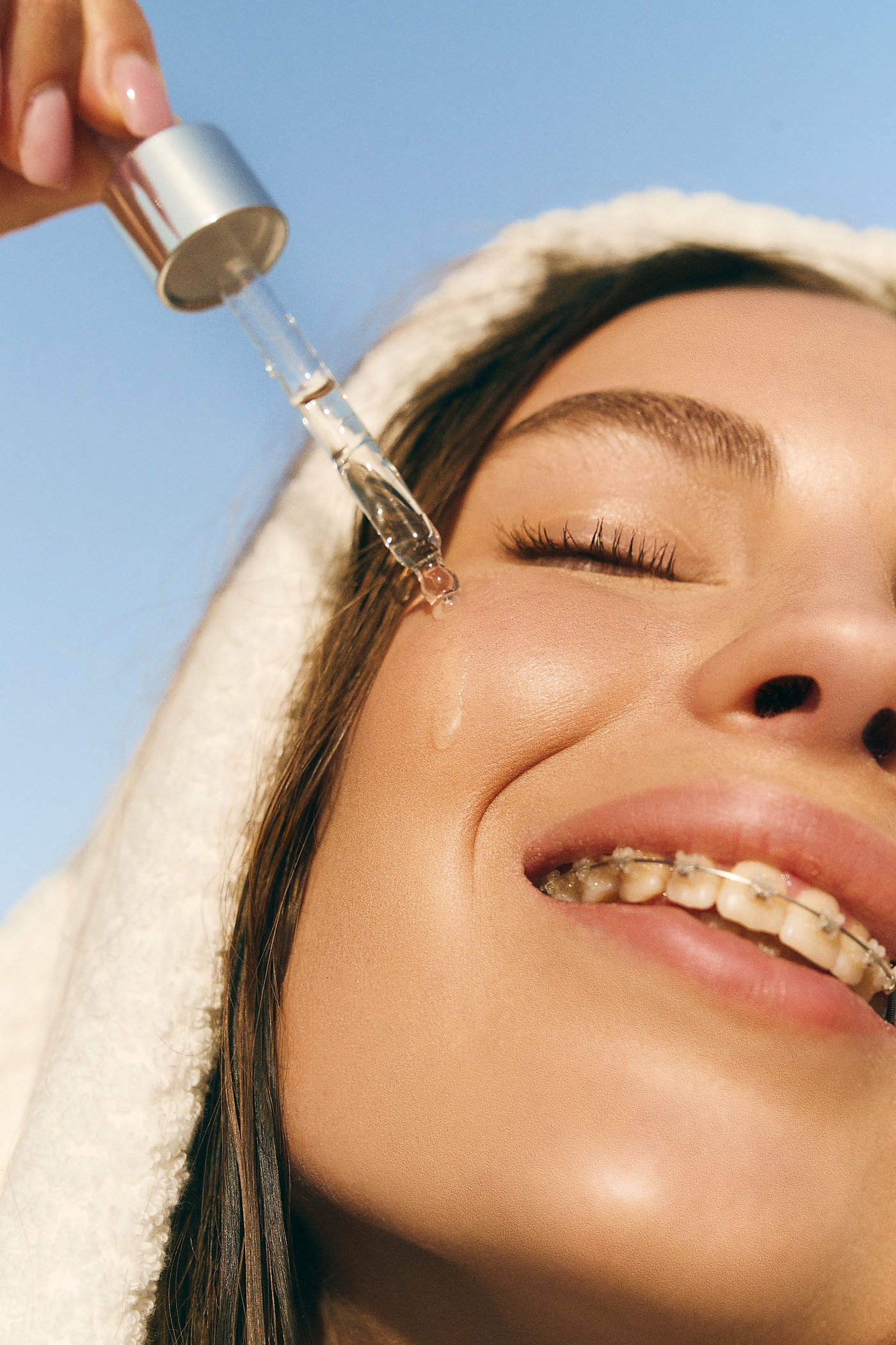 Applying SIA DEW serum with dropper