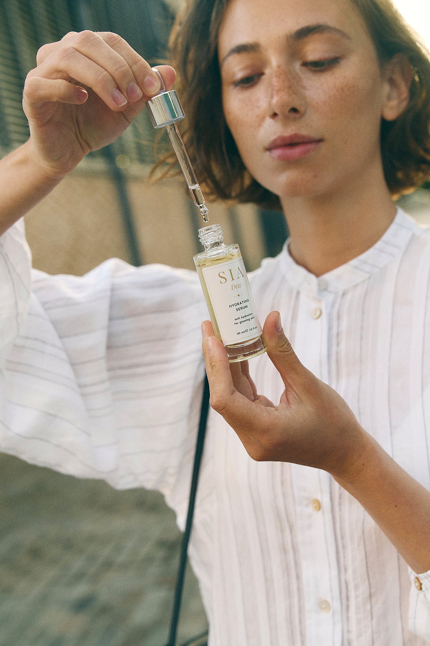 SIA DEW serum bottle in natural light
